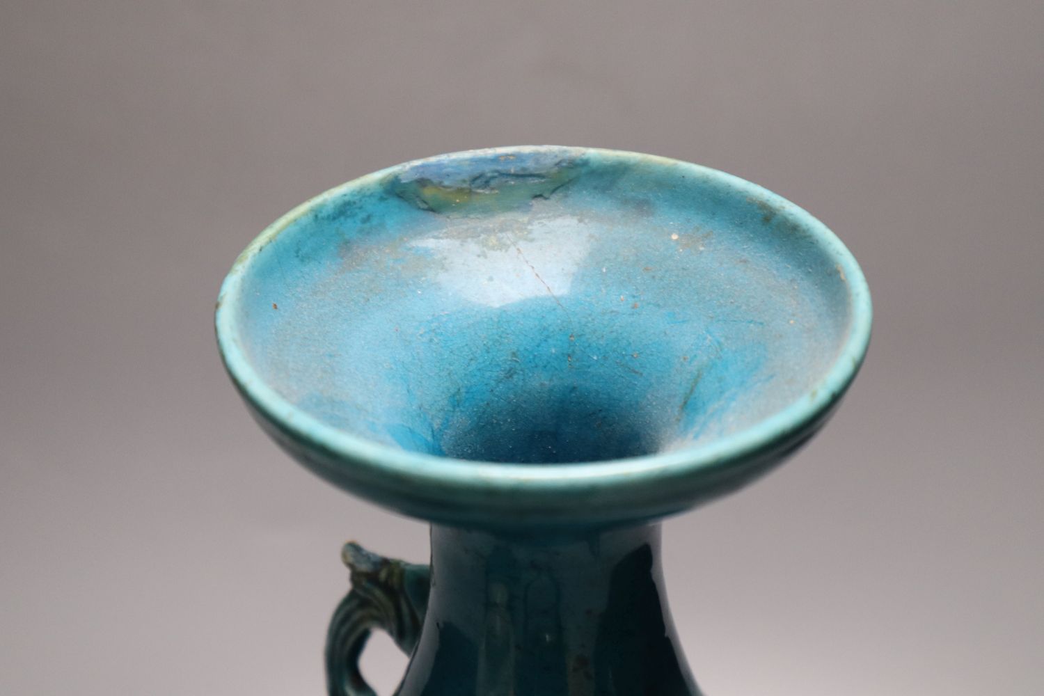 A 19th century Chinese crackleglaze squat bowl, with mask handles and a 19th century Chinese turquoise glazed baluster vase and two